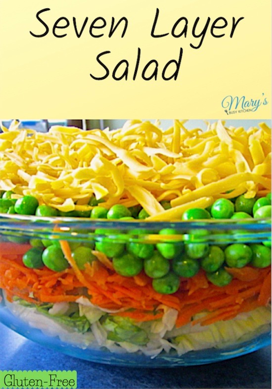 7-layered salad with carrots, peas, cheese, and bacon.