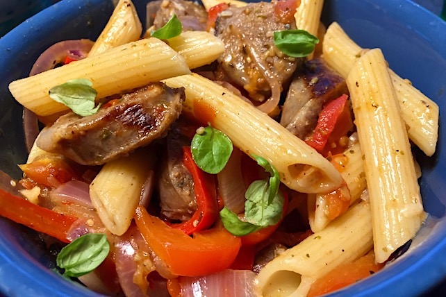 spicy one pan skillet dinner with sausage, bell peppers, onions, and pasta