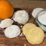 orange sugar cookies rolled in powdered sugar